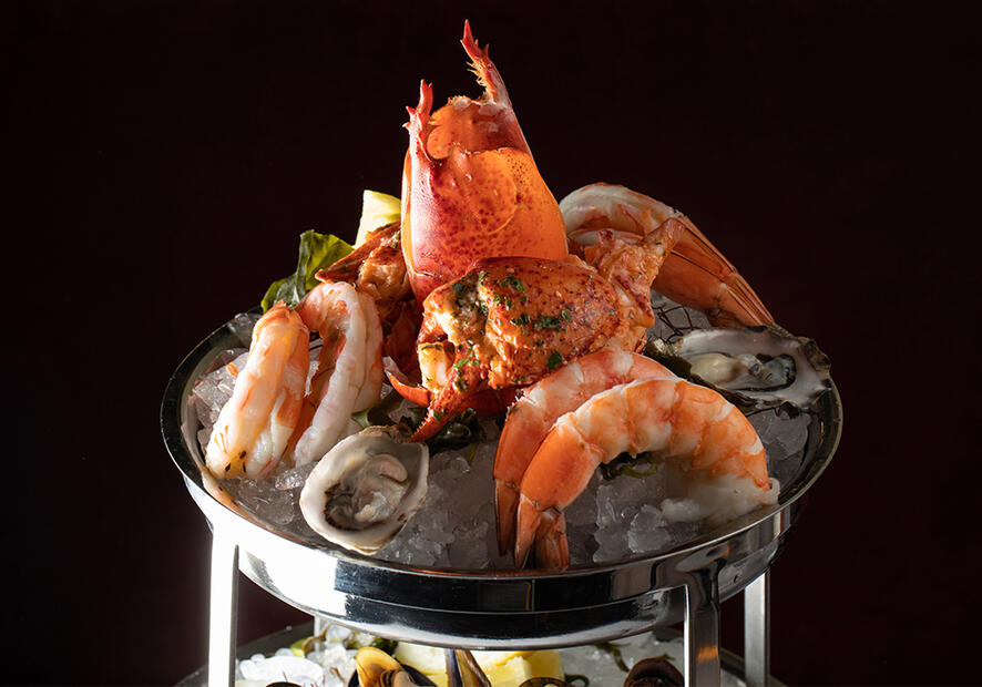 Shrimp and lobster placed on top of crushed ice for a private dining event.